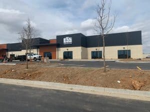 Metal building exterior with Central States Metal branding, surrounded by construction site elements and trees, reflecting durability and agricultural utility in Augusta County.